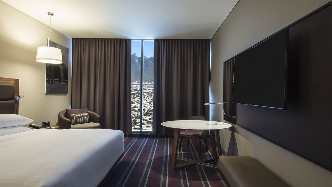 King bed, TV & Desk in Deluxe Room at FA Monterrey Pabellon M