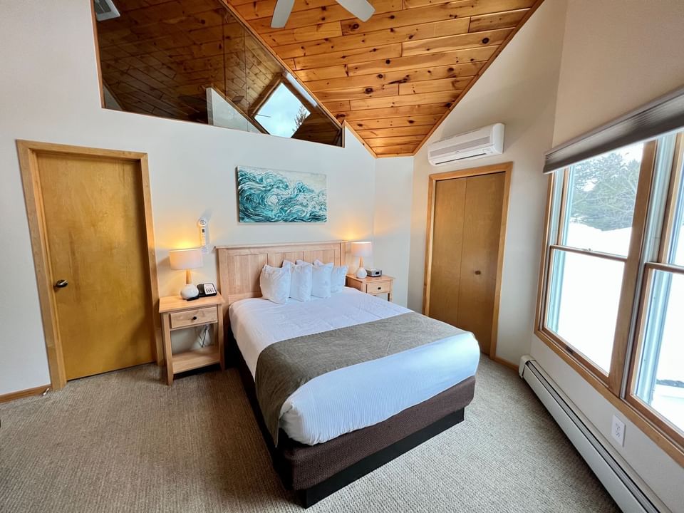 Queen bed in Hillside Guestroom, Bluefin Bay Family of Resorts