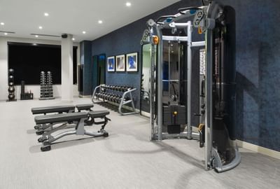 fitness center with exercise equipment, weights and benches