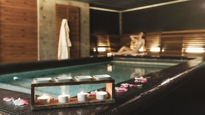 Indoor pool with candles and petals at DUPARC Contemporary Suites