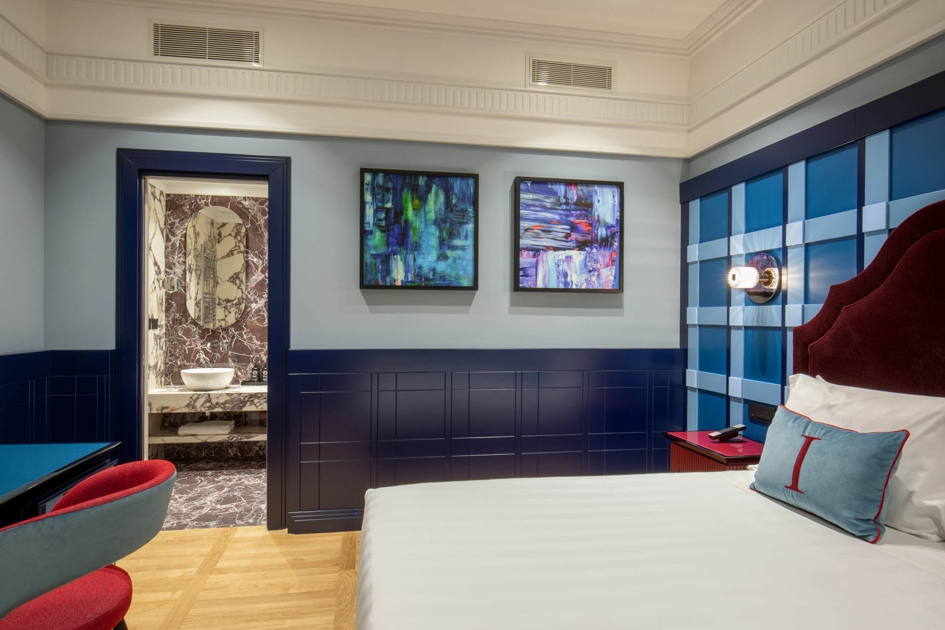 Modern Cielo Suite with stylish decor, smart bathroom entrance, and wooden floors at The Independent