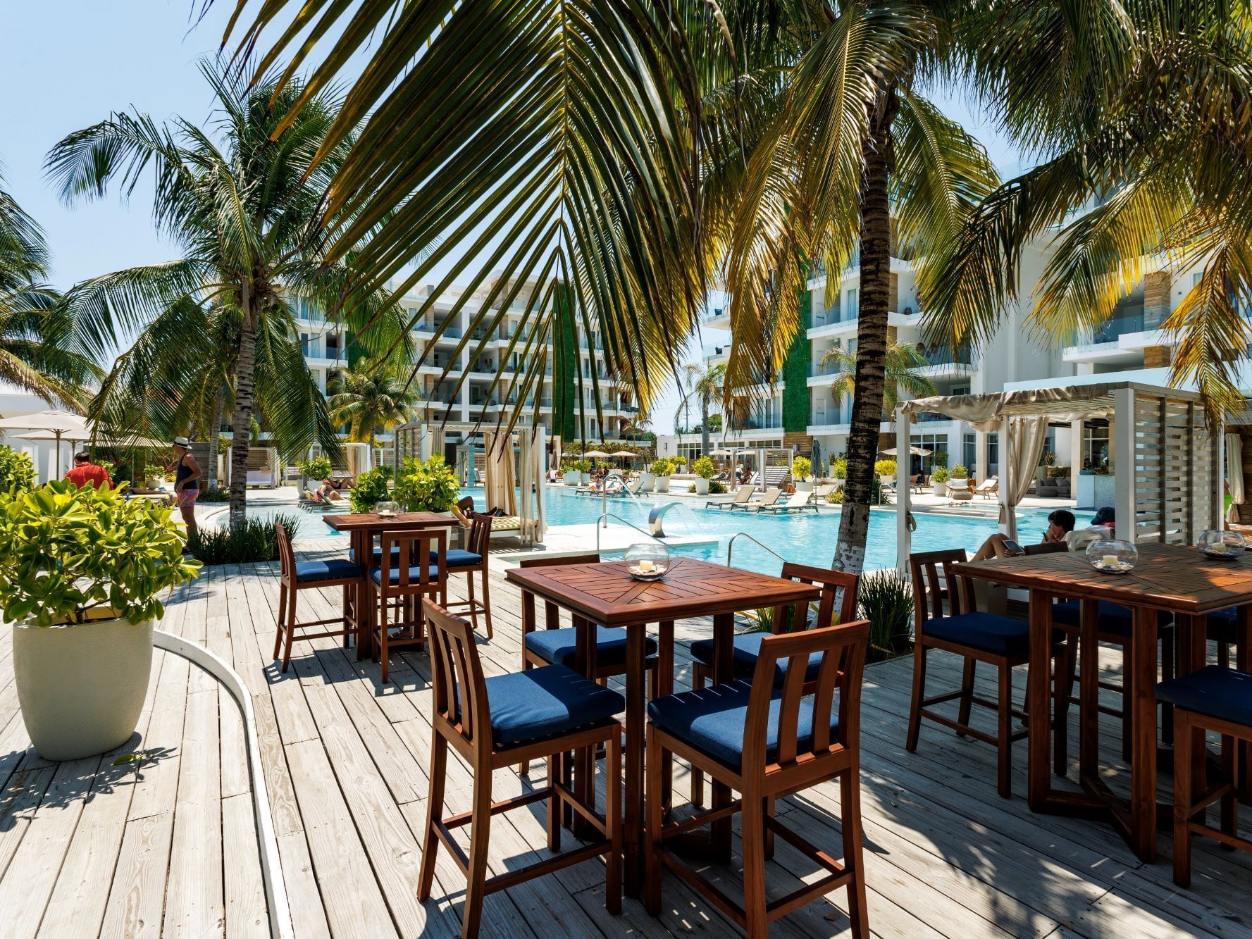 Outdoor dining area in Blue Hole Poolside at Alaia Belize Autograph Collection