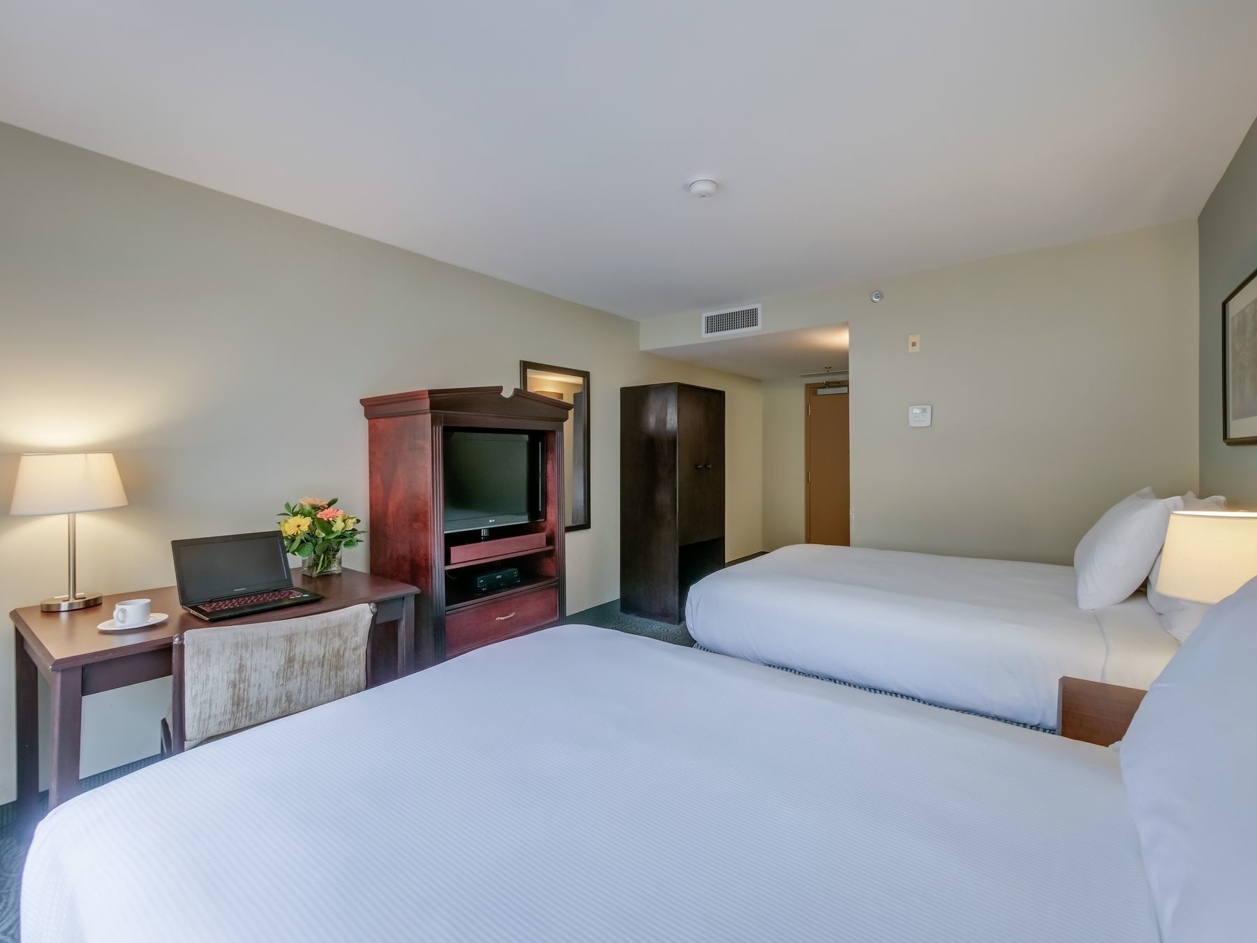 TV & work desk facing beds in Two Double Beds Room at Harrison Lake Hotel