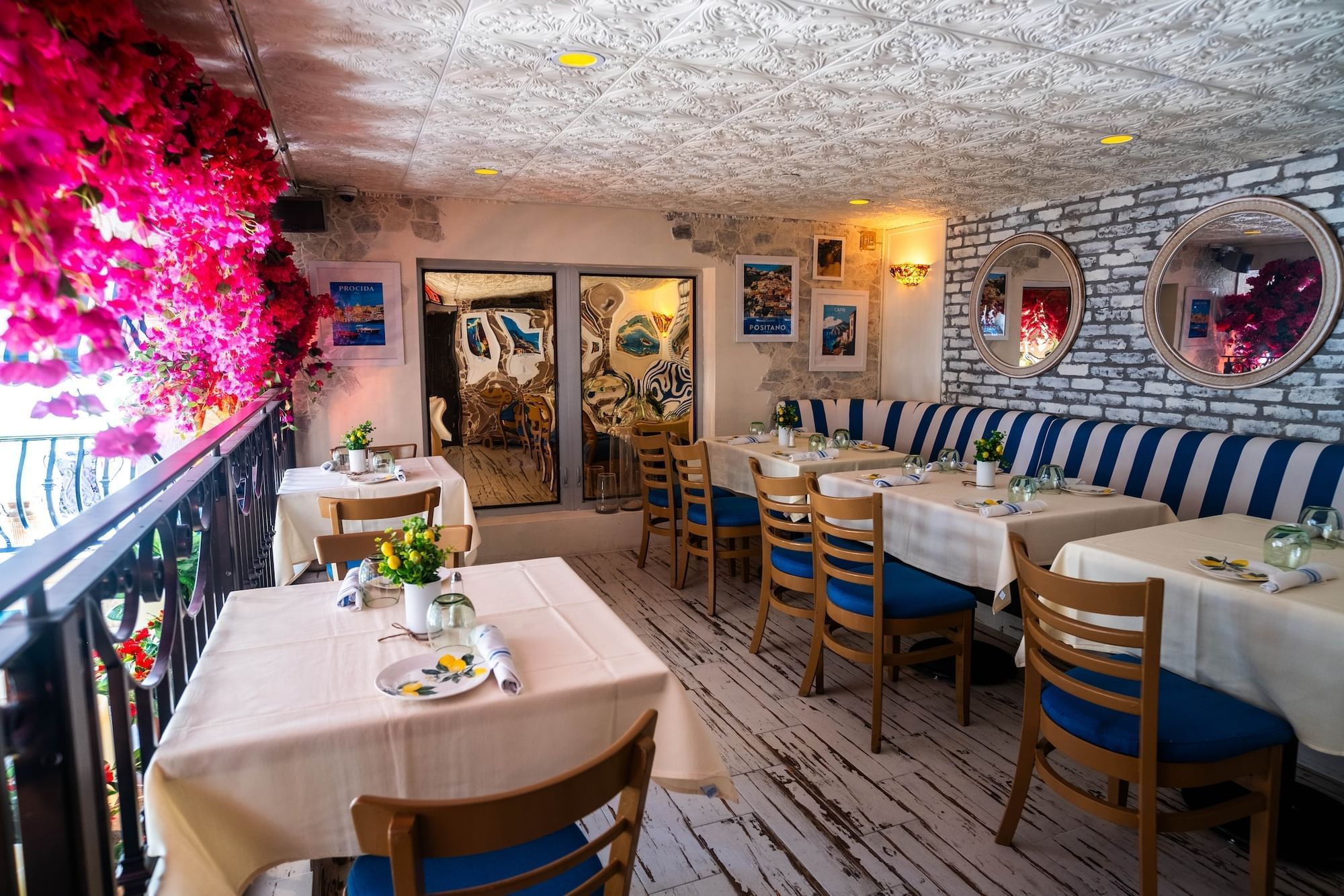 a restaurant dining area with tables, chairs, and a booth
