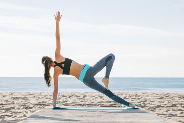 Lady engaging in yoga at the Beach by The Diplomat Resort