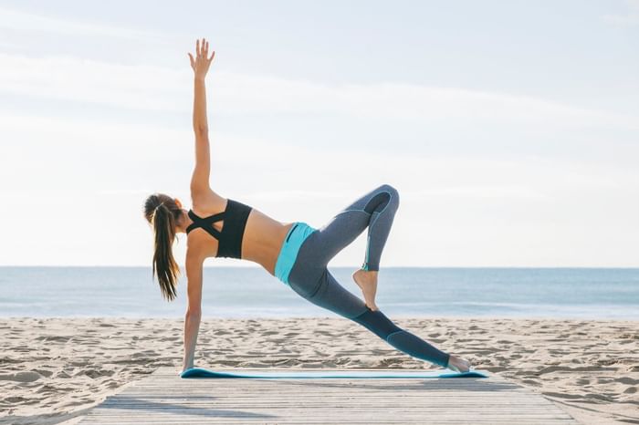 Lady engaging in yoga on the Beach near The Diplomat Resort