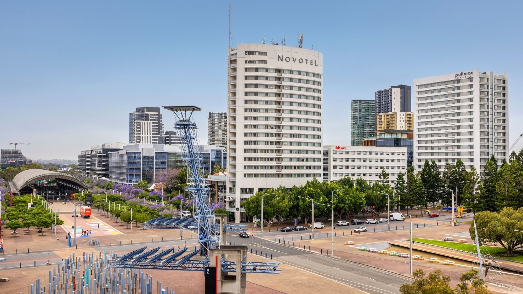 Panoramic city view with modern buildings and the Pullman Sydney Olympic Park hotel at Sydney Olympic Park.