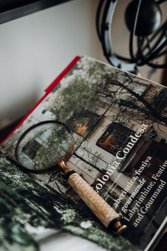 Close-up of a book & magnifying glass at Casa Mali by Dominion