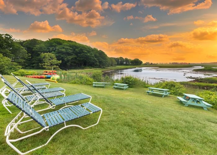 Kayaks and green picnic tables near Ogunquit River Inn at Ogunquit Collection