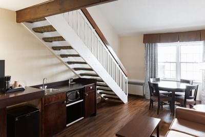 Wooden stairs next to kitchenette & dining area in Royalty Mini Loft Suite at Rodd Royalty, best Charlottetown accommodations