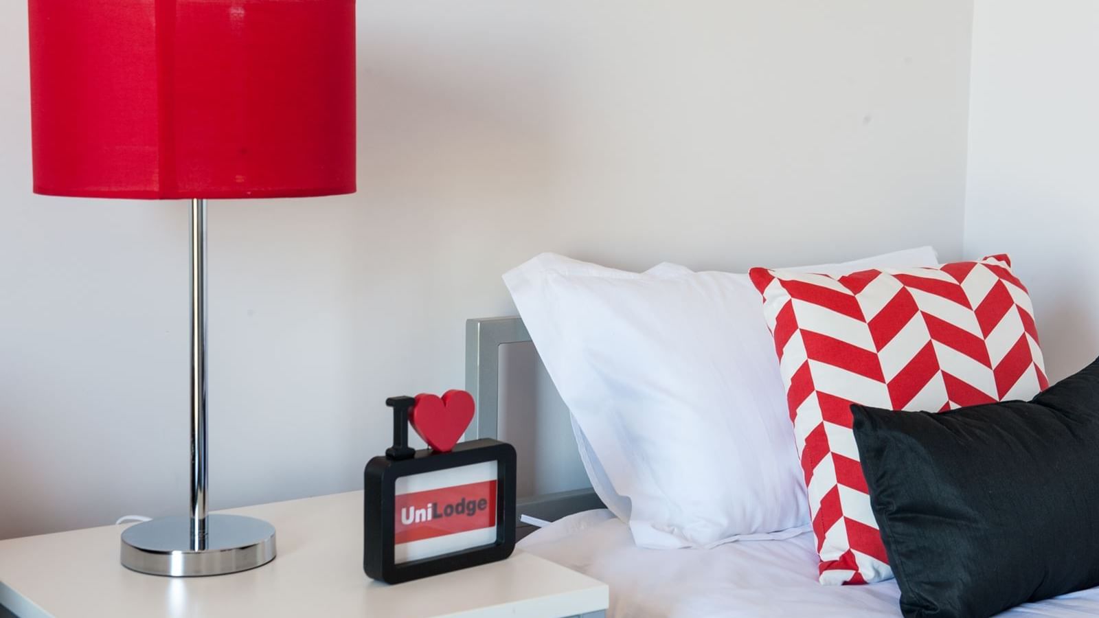 Typical studio single apartment - bed & bedside table