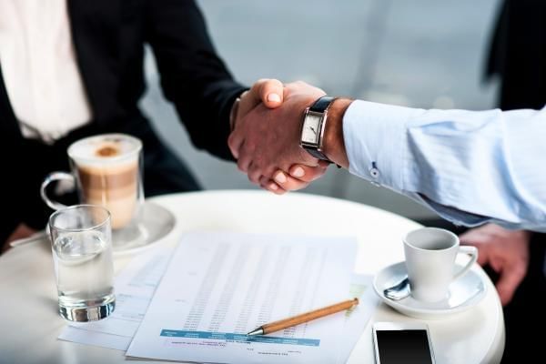 Business people at a cafe bonding and securing a deal