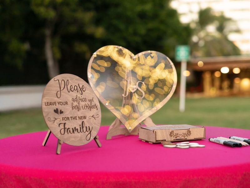 A pink table with heart-shaped signs and markers at Riviera Nayarit Resort & Spa.