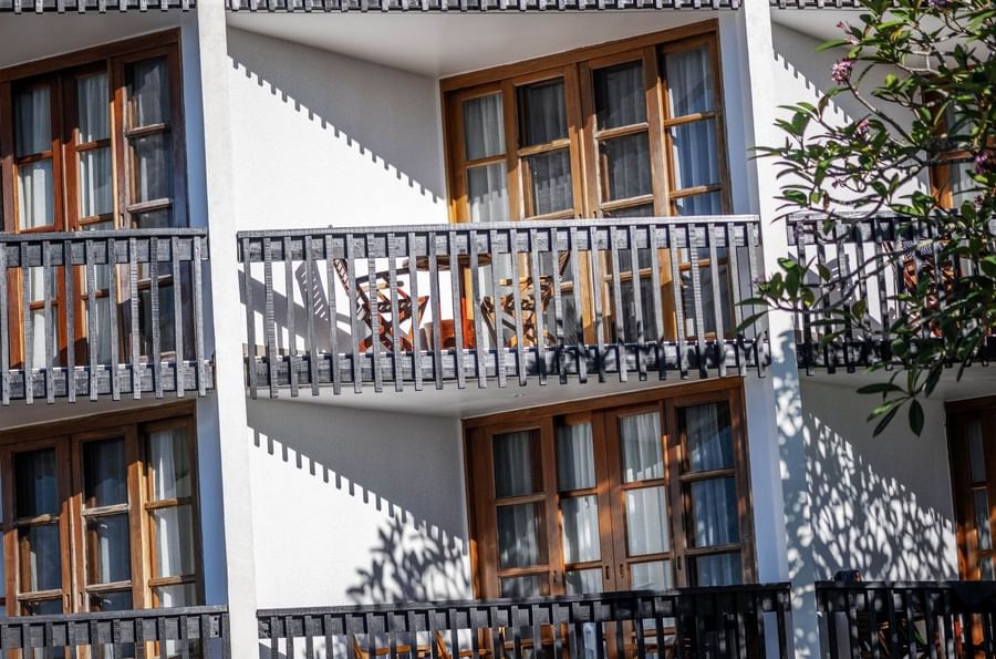 Exterior view of Room Terrace with Wooden balconies by glass doors at Warwick Fiji Resort and Spa