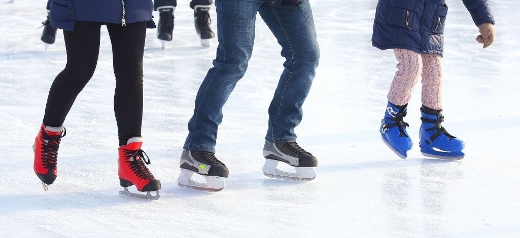 Family ice skating outdoors
