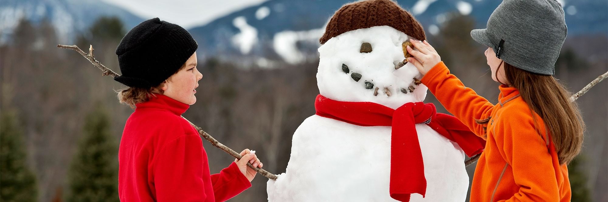Kids making a snowman.