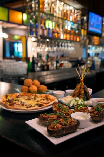 Loaded potato skins, pizza, and drinks served at RP and Whisky Bar, The Saujana Hotel Kuala Lumpur