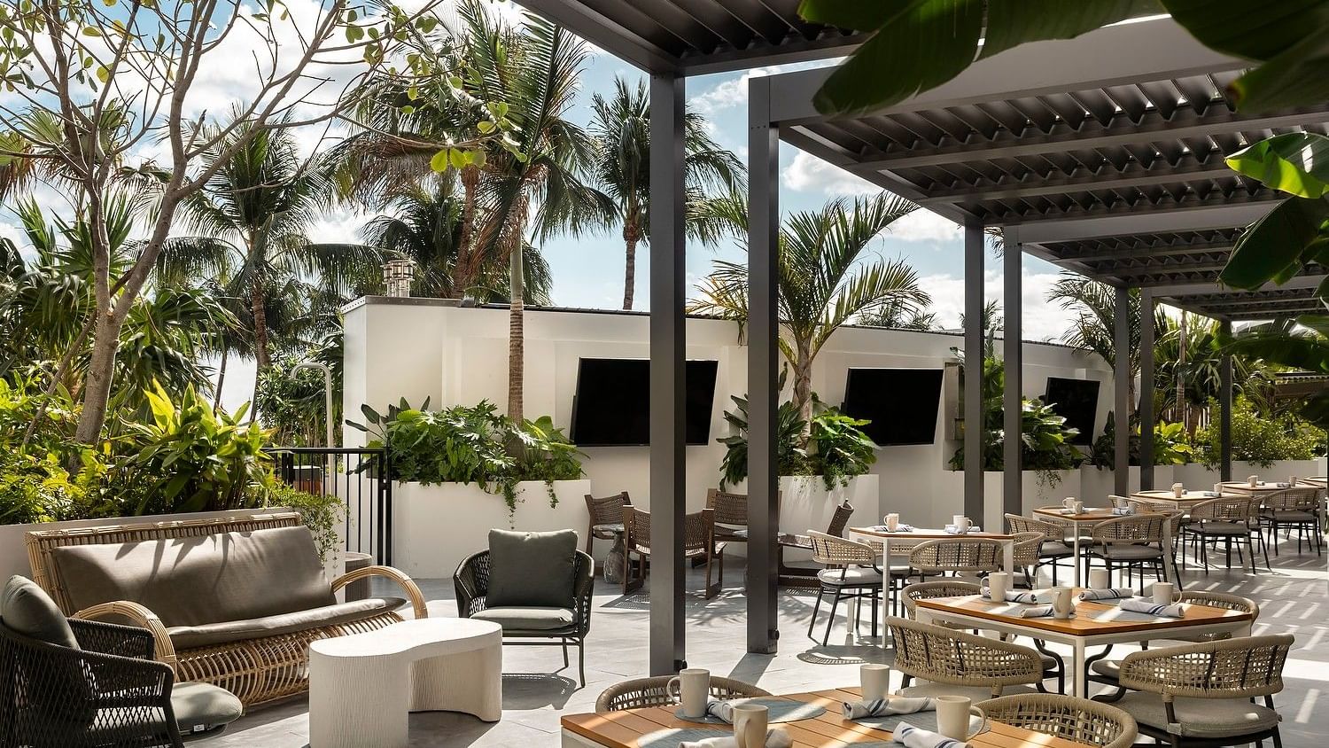 Sunlit patio seating outside the Mediterranean-style breakfast restaurant.