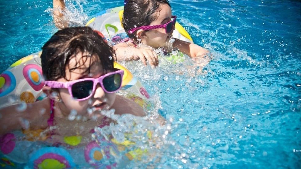 Two children with floatation rings splashing in a pool at Sunway Hotel Big Box