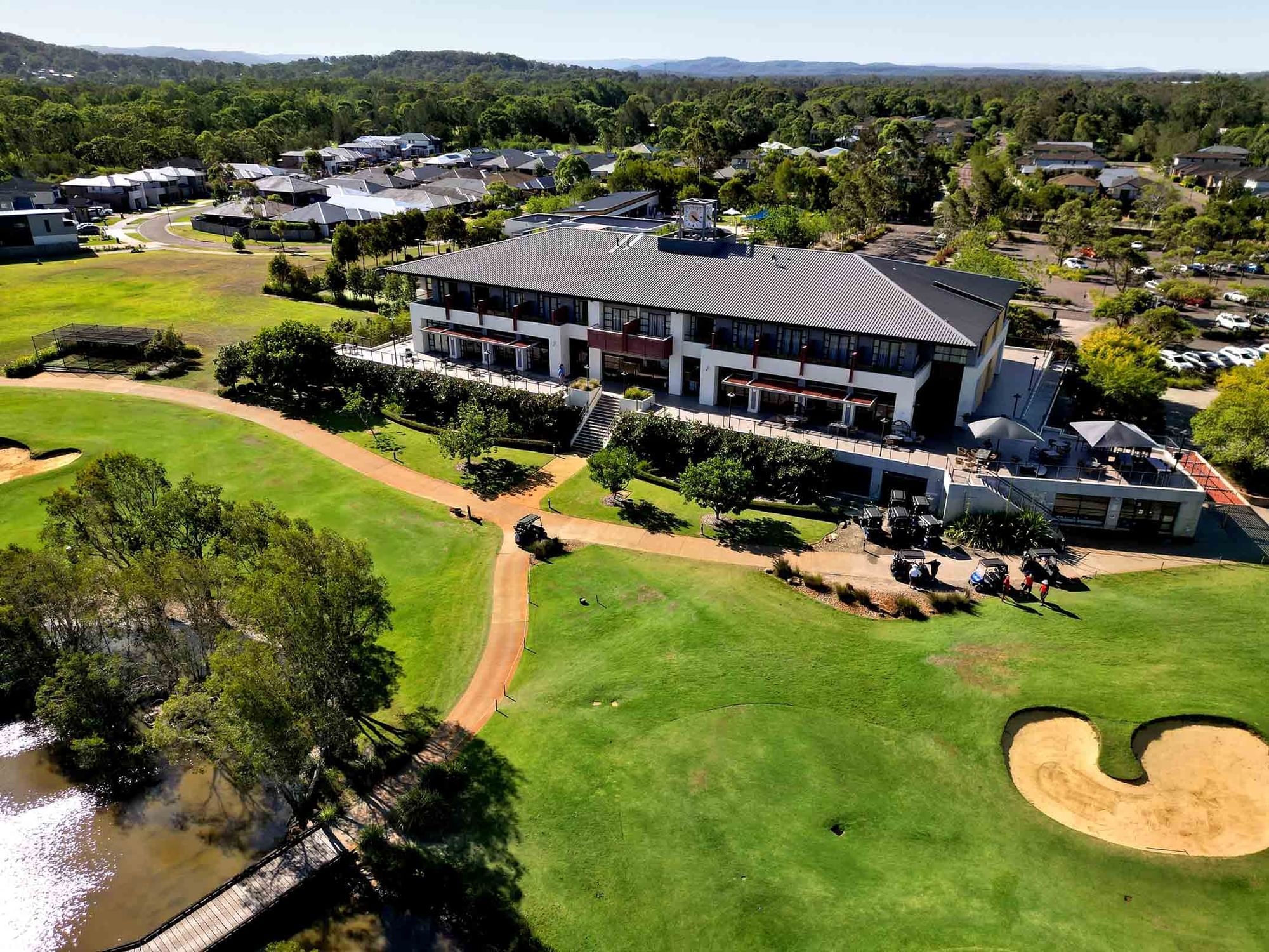 Stunning view of clubhouse with golf course and lake at Mercure Kooindah Waters