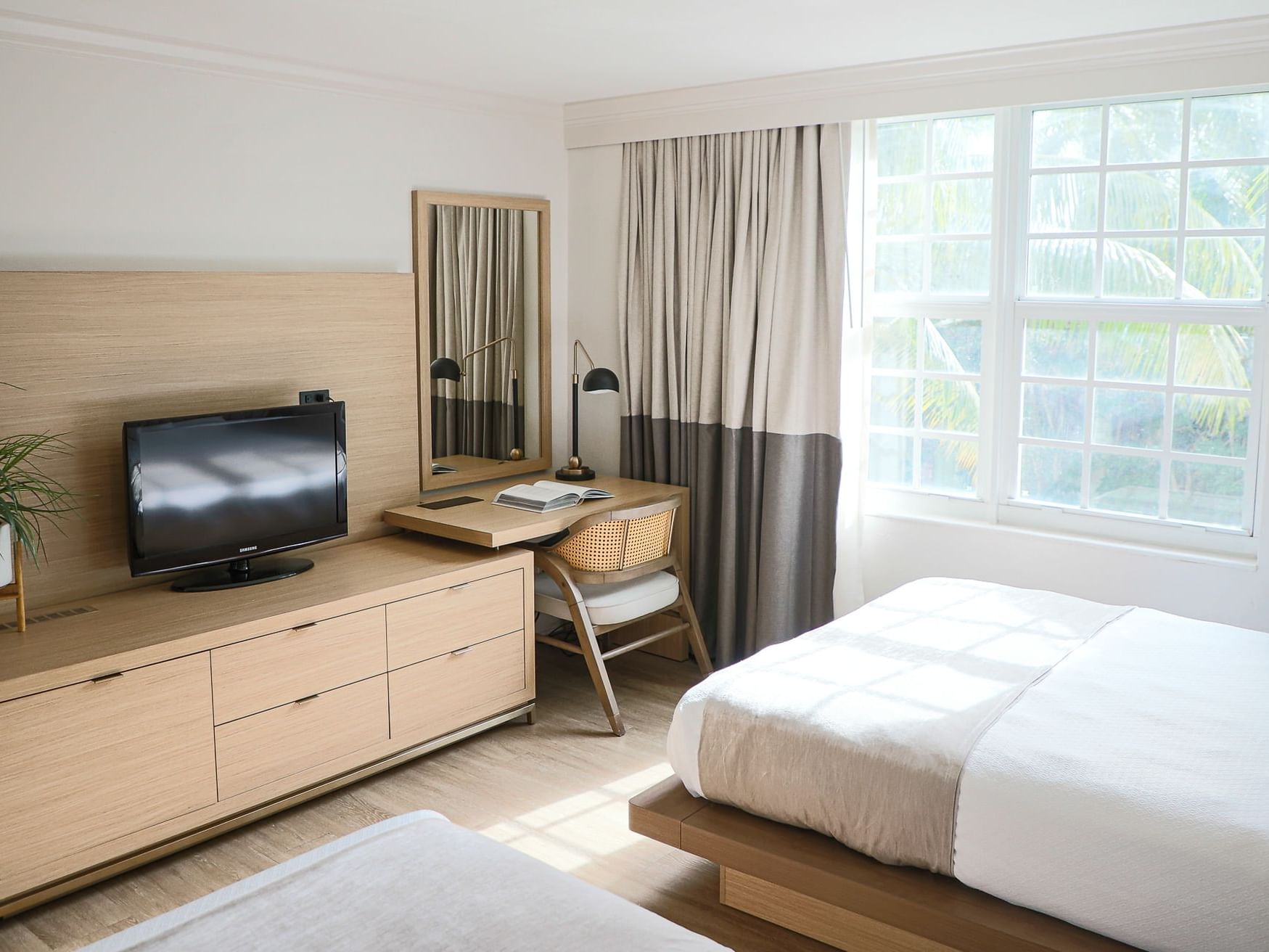 Standard Room with two twin beds, wooden furniture, a desk, and a TV at Riverside Hotel Fort Lauderdale