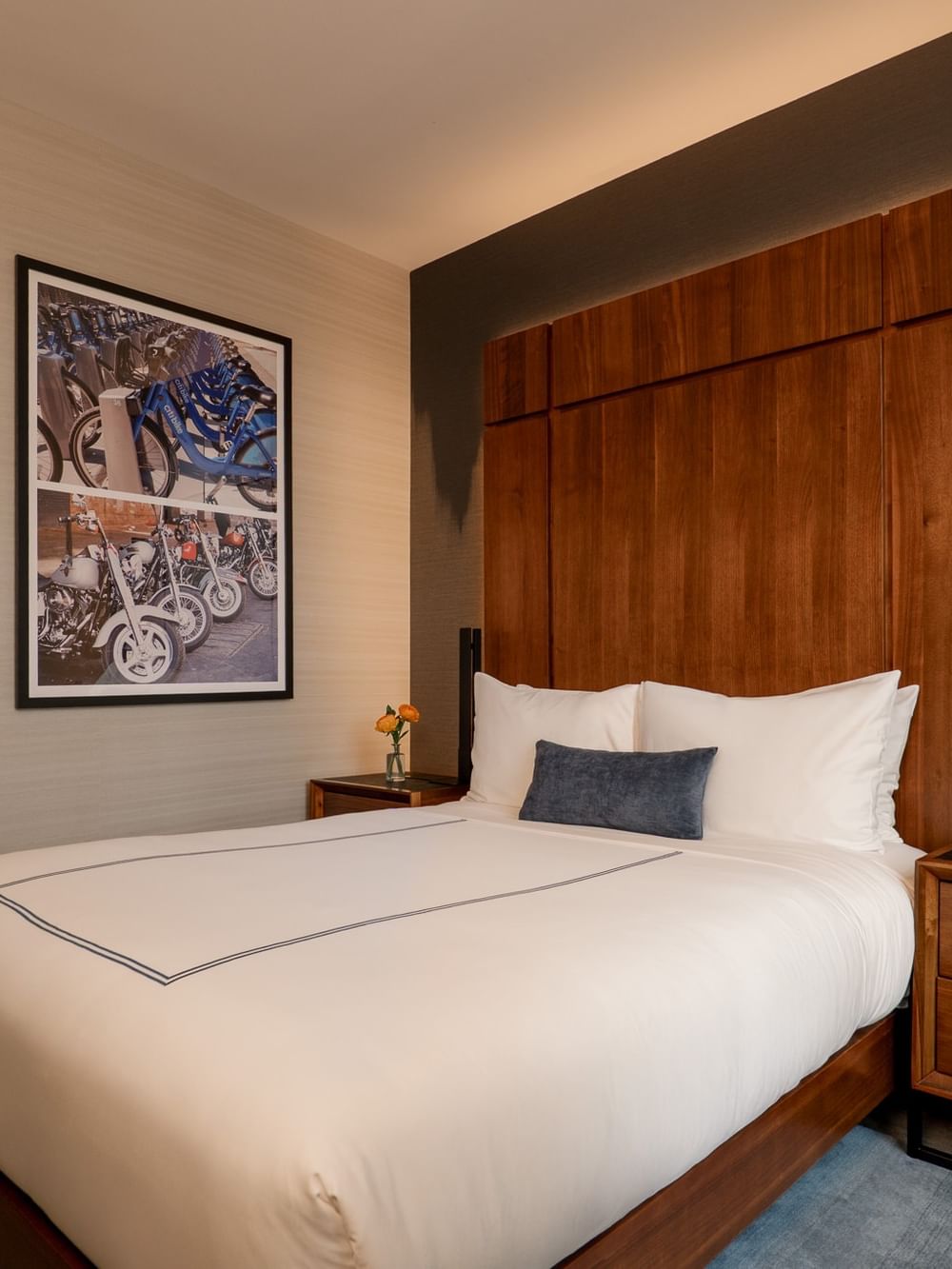 Modern Accessible Superior Room with white bedding, wooden headboard, and contemporary artwork at Gansevoort Meatpacking NYC.