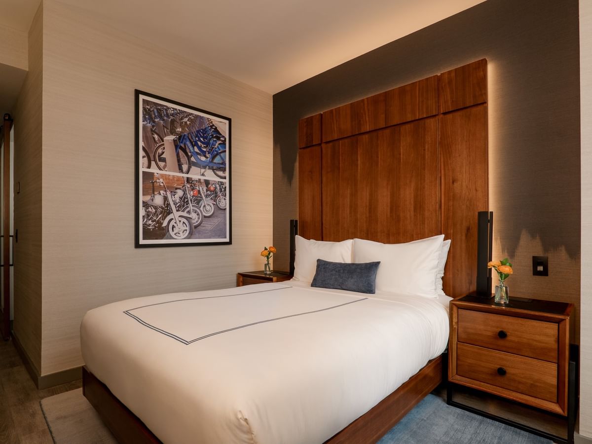 Modern Accessible Superior Room with white bedding, wooden headboard, and contemporary artwork at Gansevoort Meatpacking NYC.