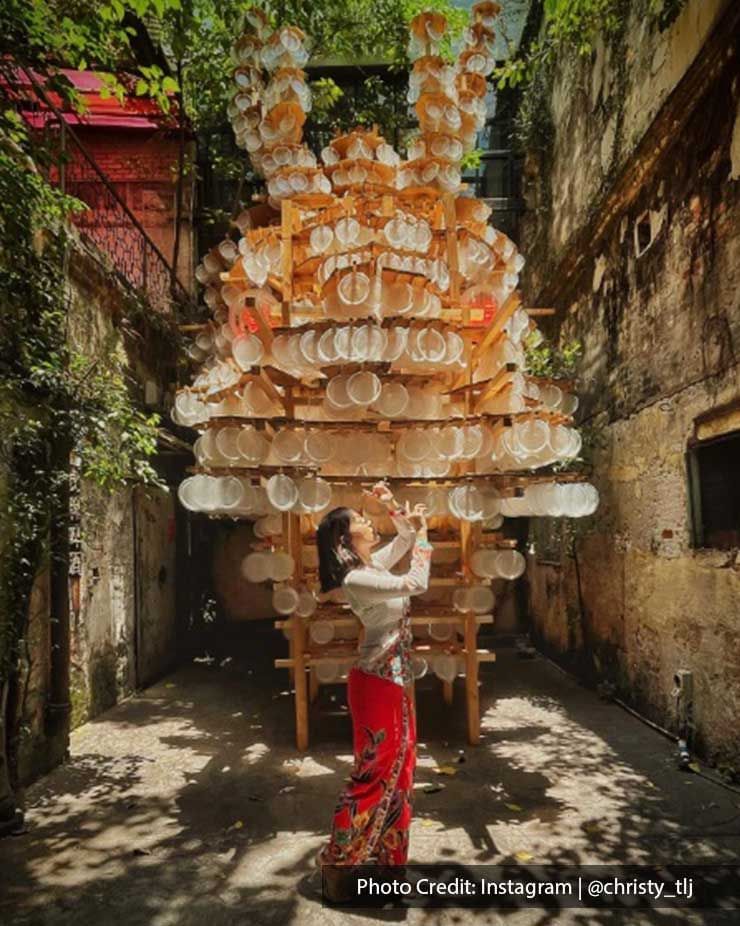 Lady wearing a festive costume posing in Kwai Chai Hong Street, a famous attraction near Imperial Lexis Kuala Lumpur