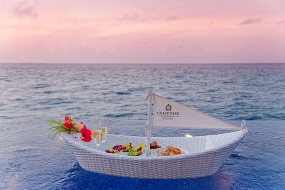 A boat laden with food and drinks floats on the ocean near Grand Park Kodhipparu, Maldives