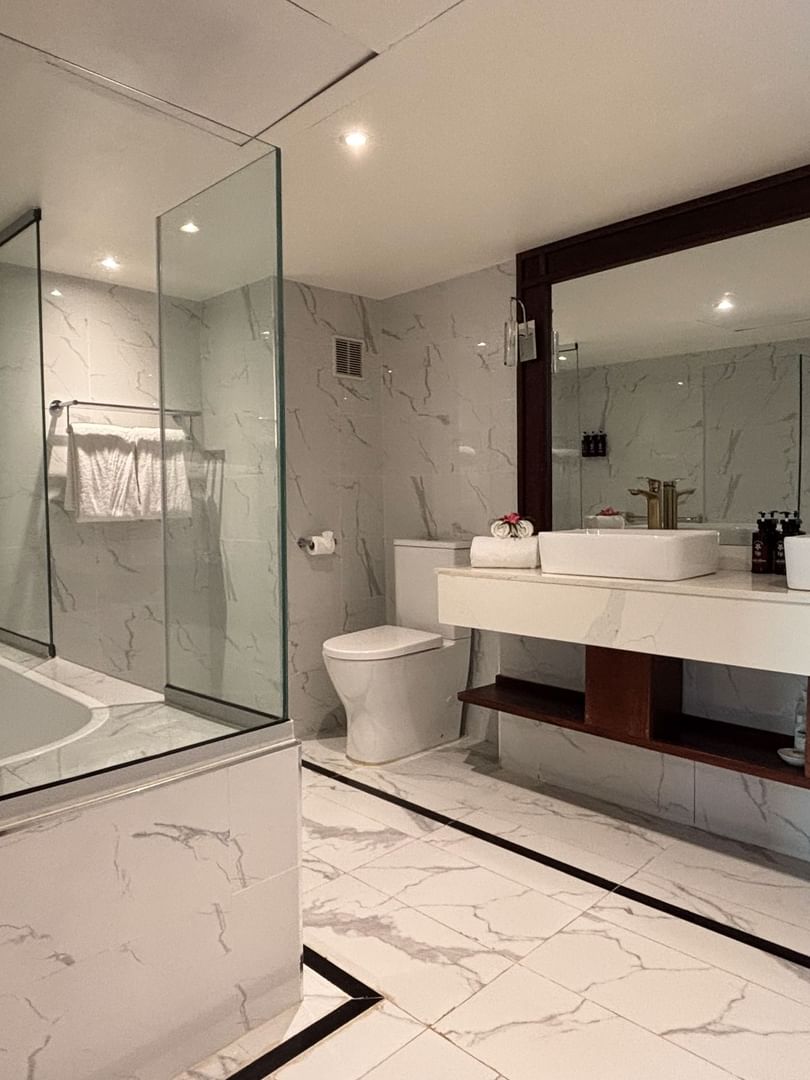 Modern bathroom with walk-in shower and dual vanity at Warwick Fiji Resort and Spa in Korolevu.