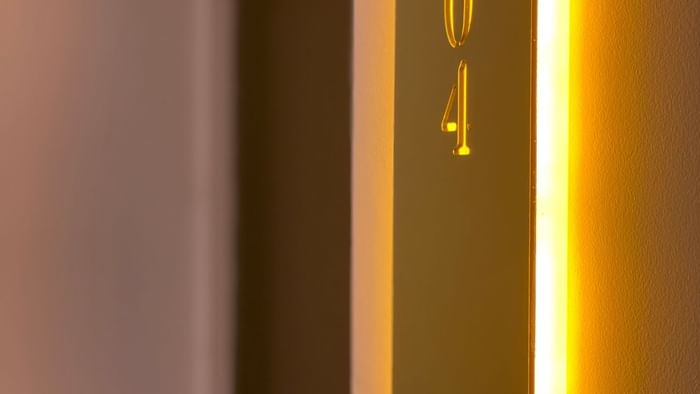 Close-up of a room number plate at The Originals Hotels