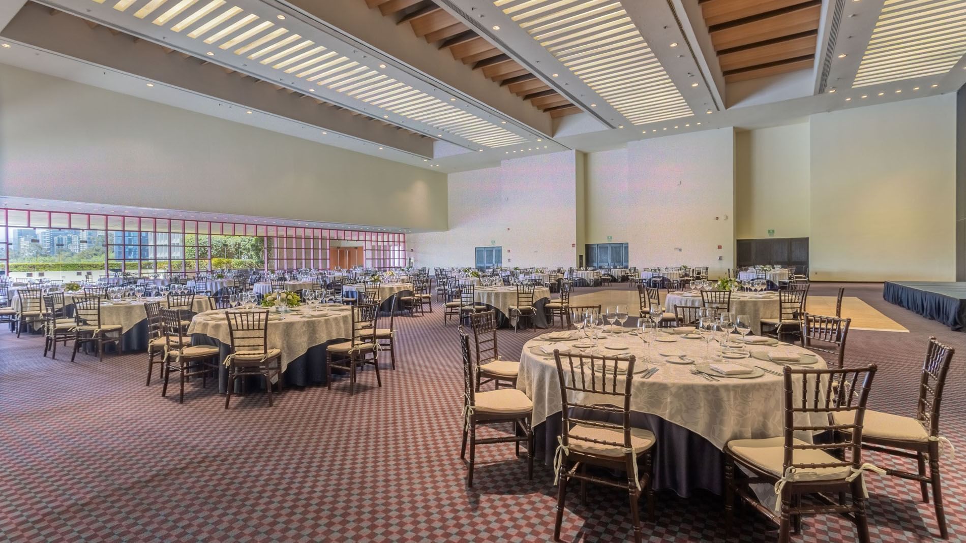 Monterrey C ballroom featuring many set tables, high ceilings, and unique slatted lighting at Camino Real Polanco Mexico