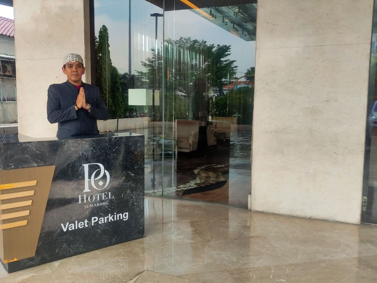 Receptionist by the front desk in the Valet Parking at Po Hotel Semarang