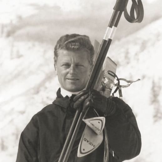 Portrait of a man holding snow skis at Stein Lodge at winter