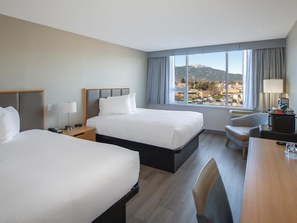 Two queen beds hotel room at Coast Chilliwack Hotel by APA.