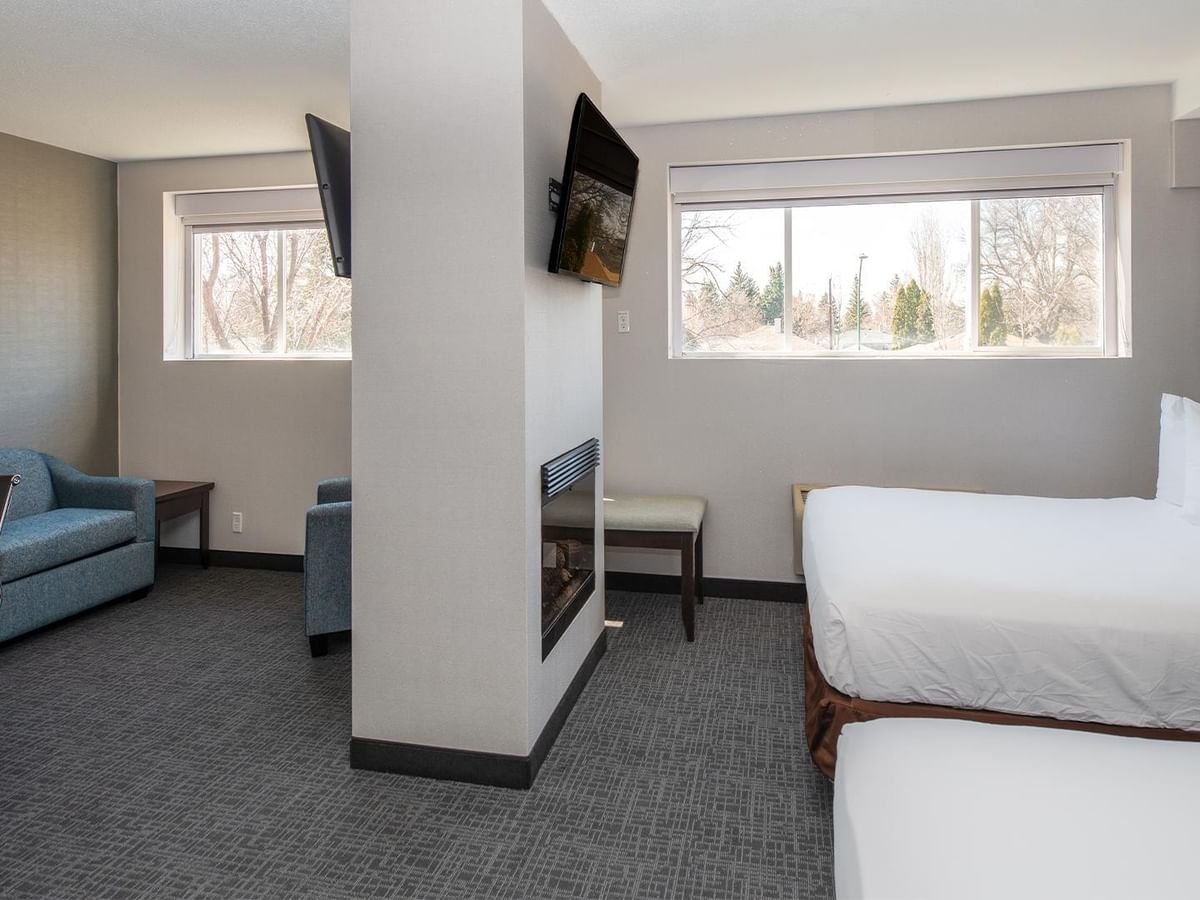 Two queen beds, a couch, and a TV