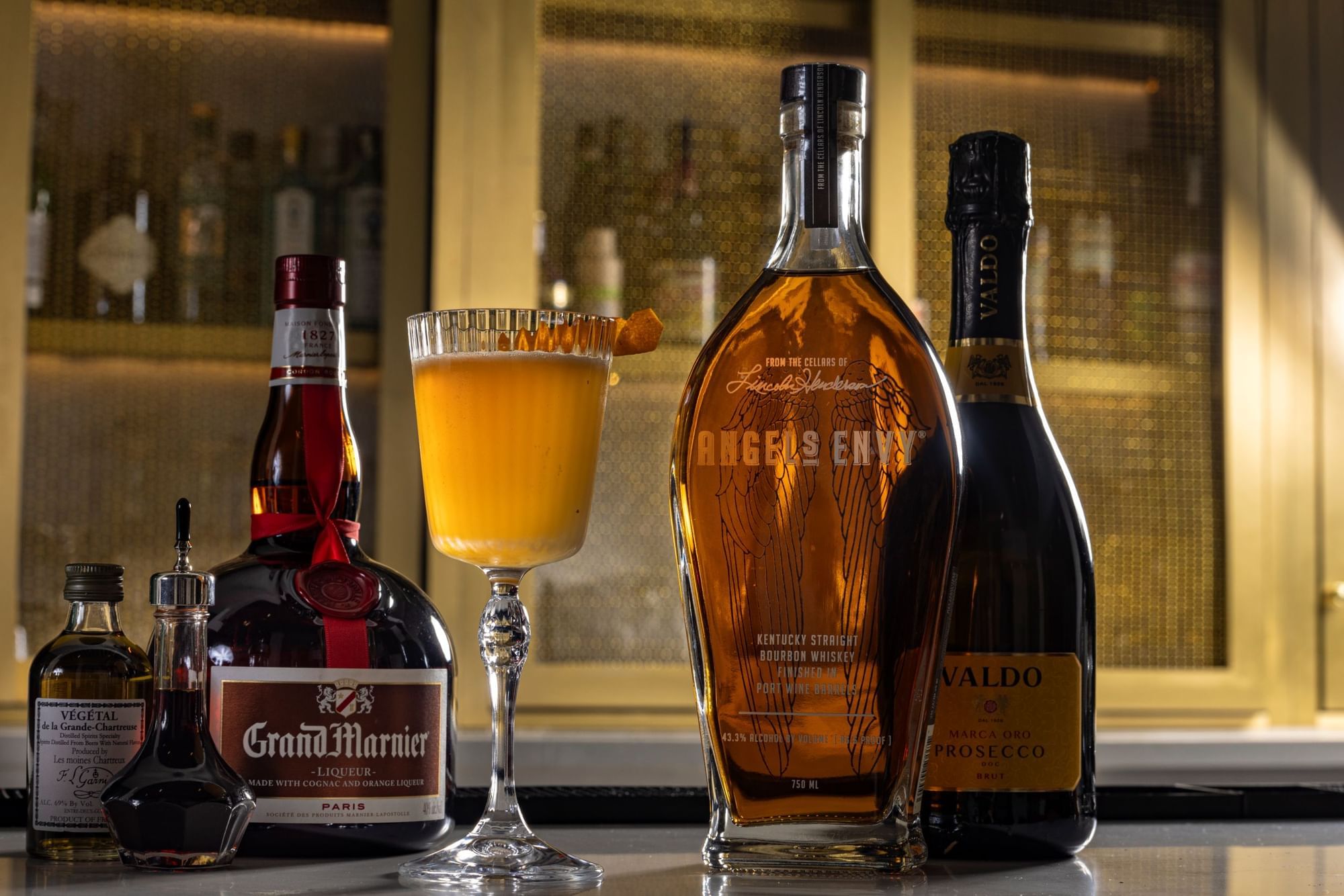 a bar with bottles and a cocktail glass