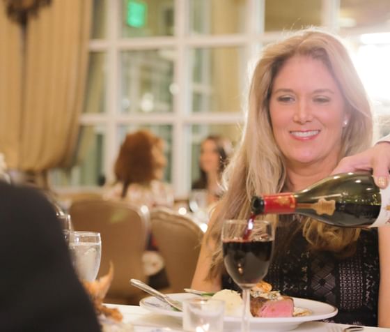 Woman being poured a glass of red wine at Safety Harbor Resort