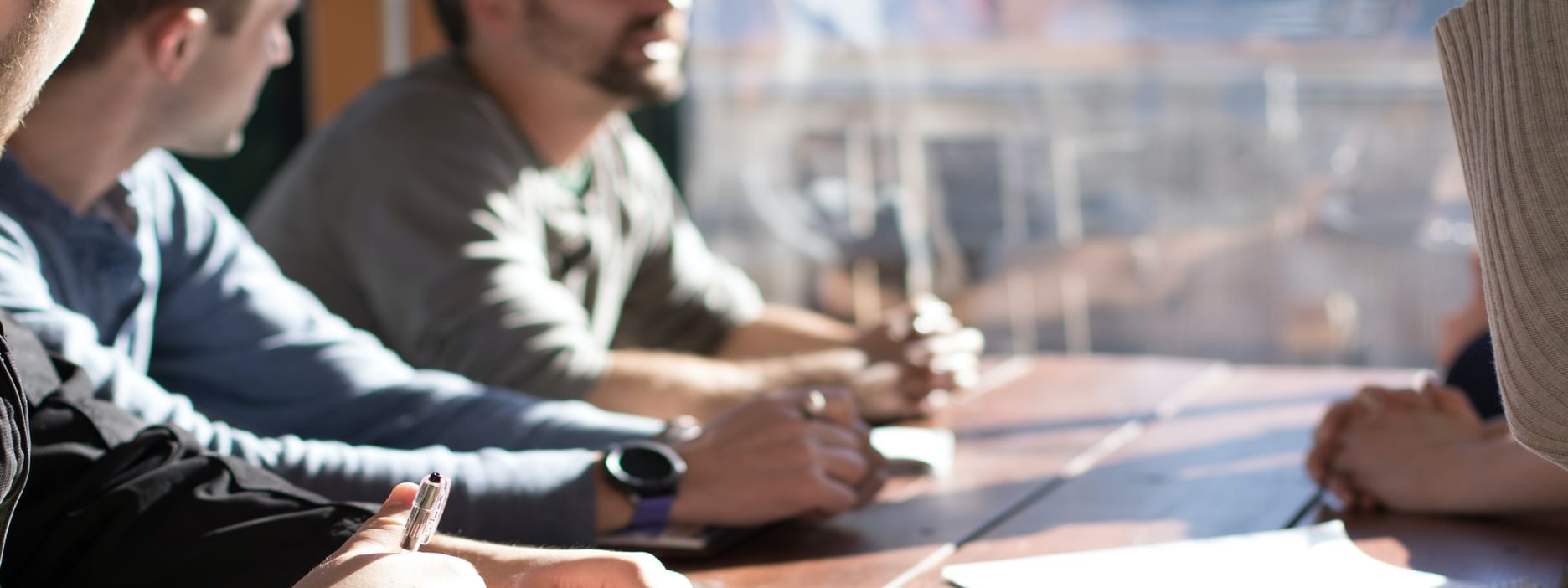 Person sitting by table with hands clasped in a meeting place at Pullman Port Douglas Sea Temple Resort & Spa