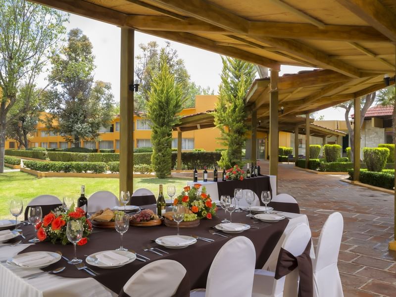 Table arranged with wine & flowers in the Garden at Gamma Pachuca