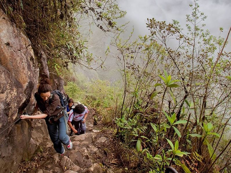 Tourists climbing the Machu Picchu Mountains near Hotel Sumaq