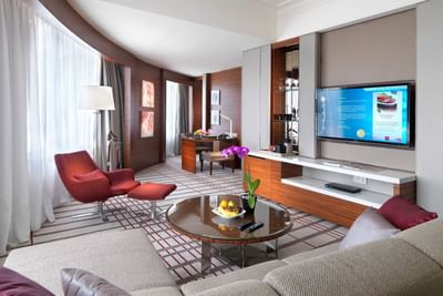 Modern living room with lavish interior & decor in Junior Suit with carpeted floors, A One World Hotel room