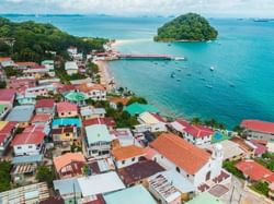 The view of the Tabago Island from the sky with houses and the sea