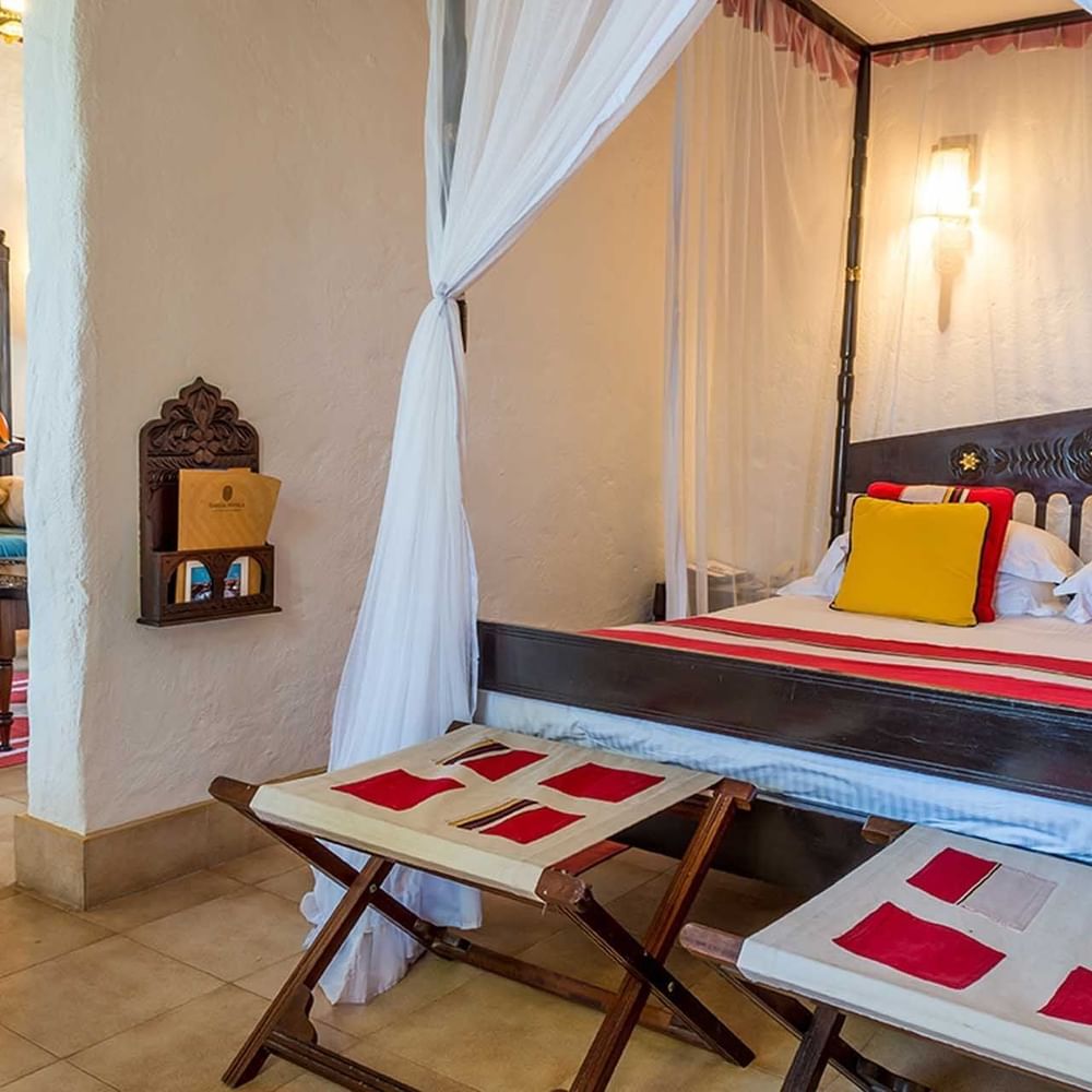 Lamu Suite with canopy bed and seating area at Serena Beach Resort & Spa, Mombasa.