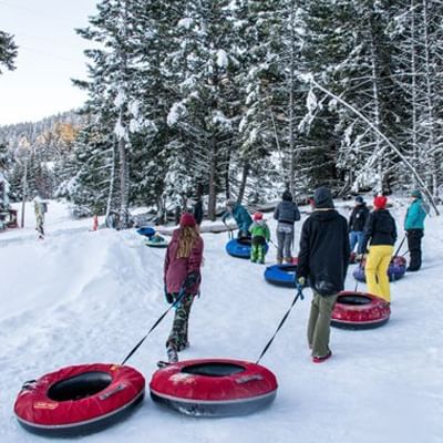 People pulling tubs in the snow