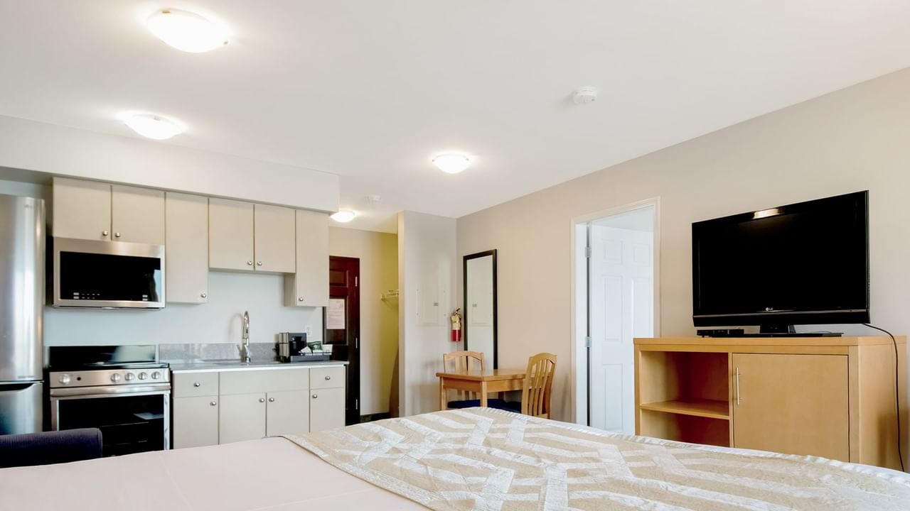 Bed with steel Kitchen appliances and TV