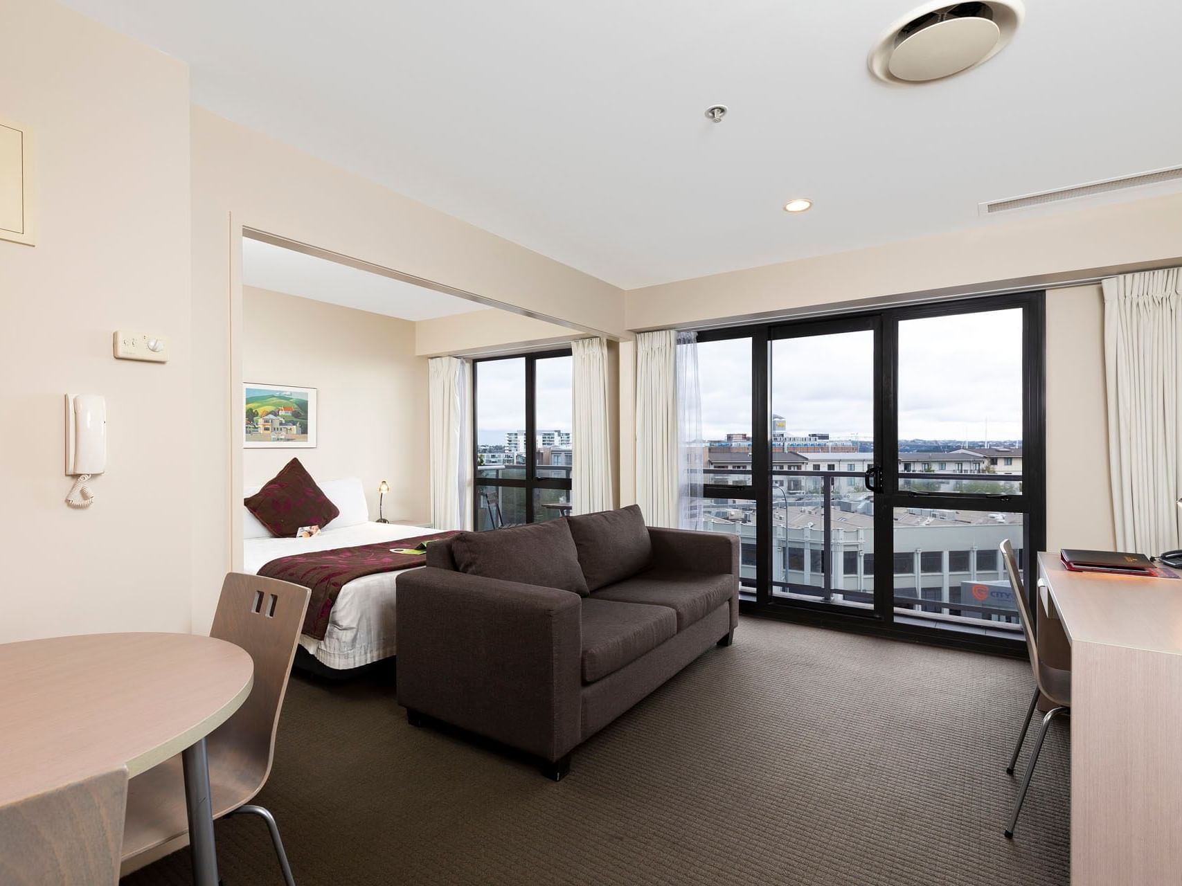 King bed & lounge area in One Bedroom Suite at Hotel Grand Chancellor