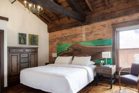 Comfy Bed, nightstand & chair in Apartment 404 at Retro Suites Hotel