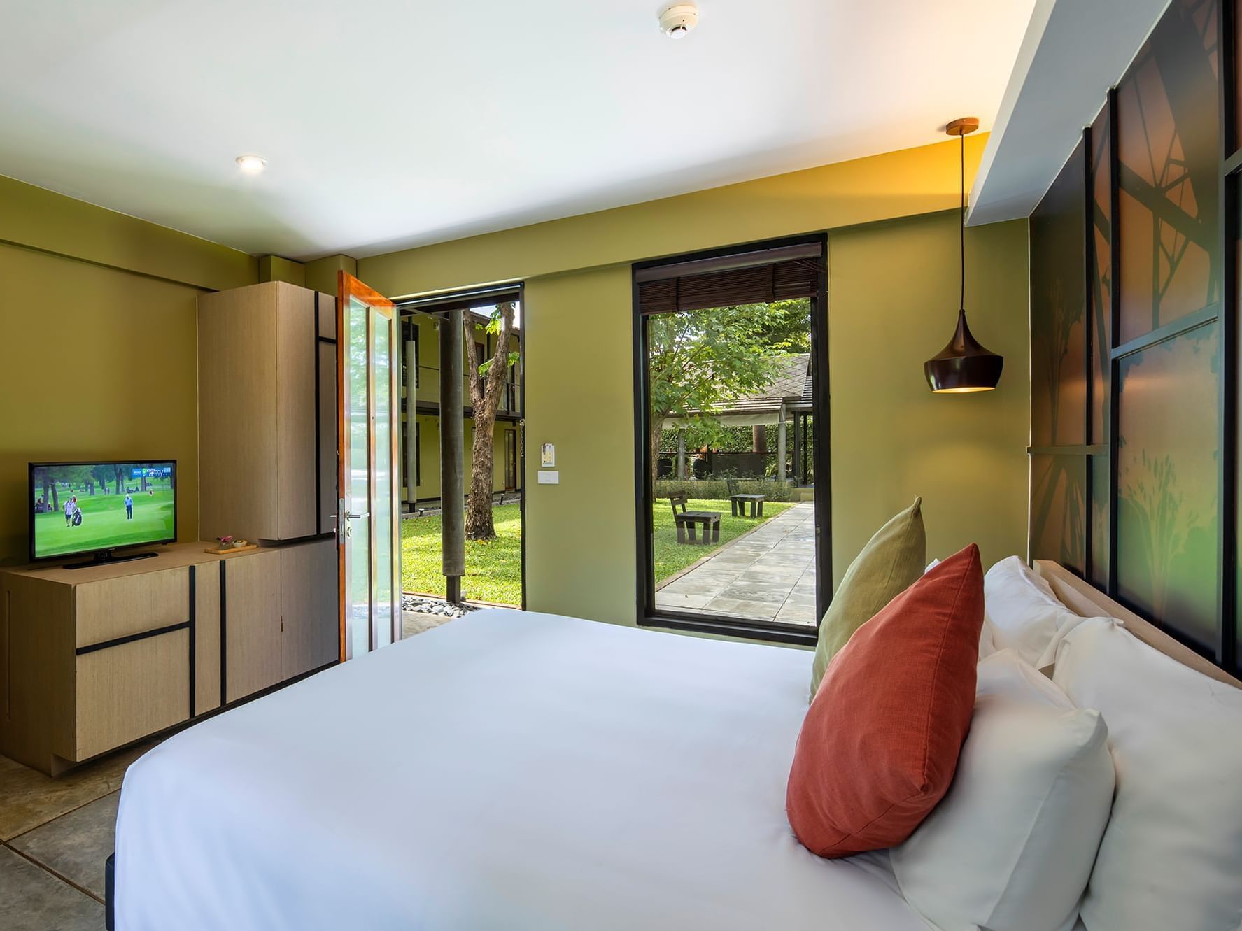 Comfy bed and TV in Superior Garden View Room at U Hotels