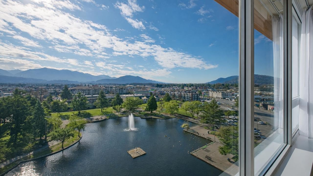 View of pond and mountains from hotel room window.